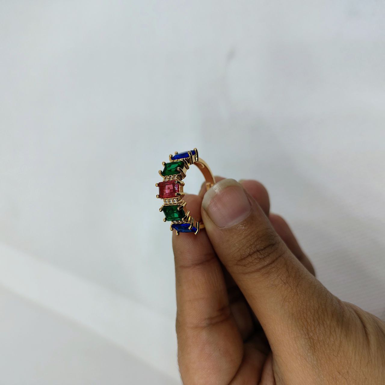 vibrant gold ring adorned with colorful gemstones,